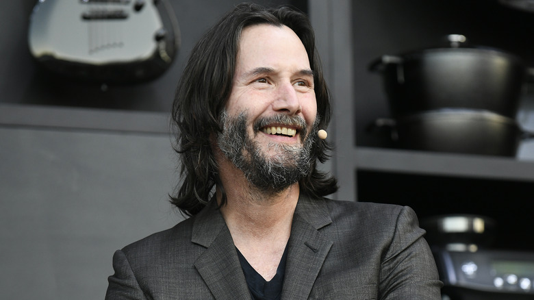 Keanu Reeves smiling at culinary presentation