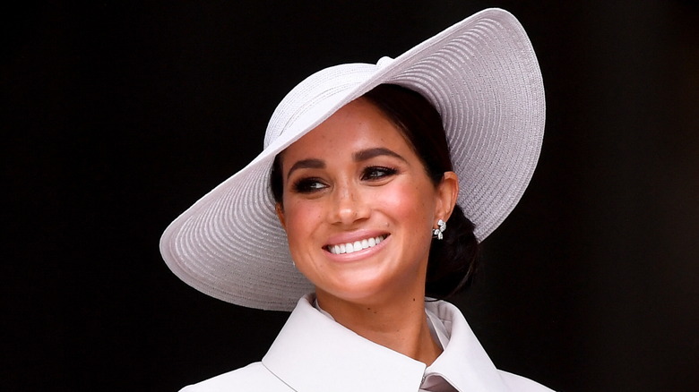 Meghan Markle smiling in white