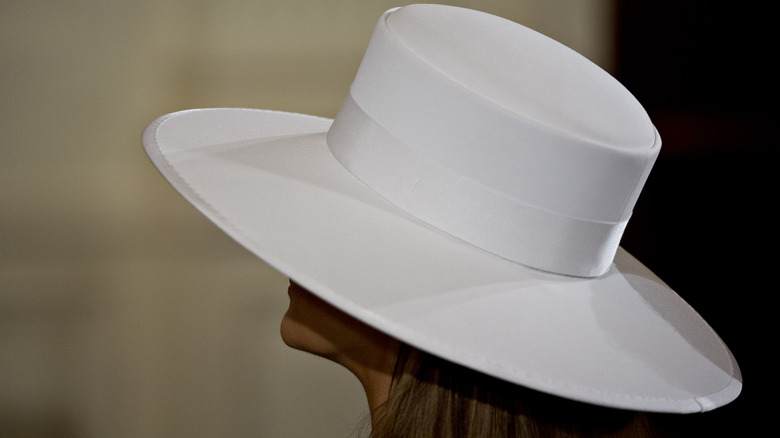 Melania Trump wearing a white hat in the White House