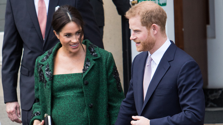 Prince Harry and Meghan Markle hold hands