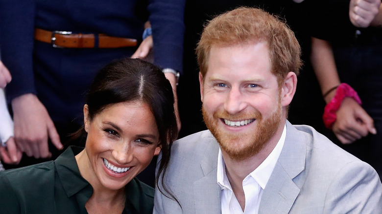 Meghan Markle and Prince Harry smiling at an event