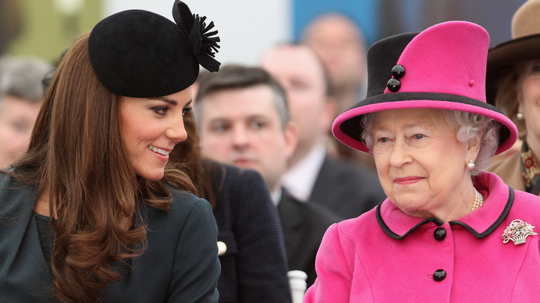 Kate Middleton and Queen Elizabeth sitting next to each other