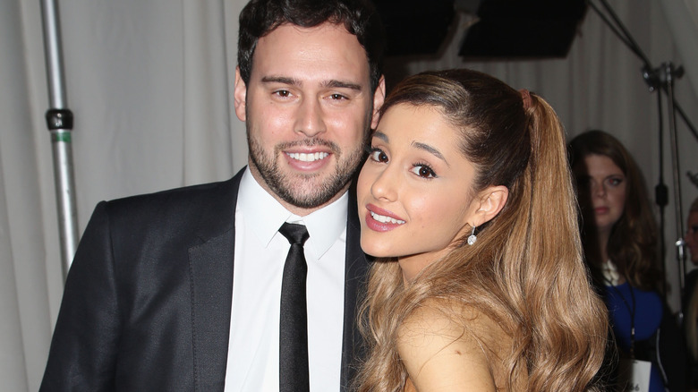 Scooter Braun and Ariana Grande smile side by side