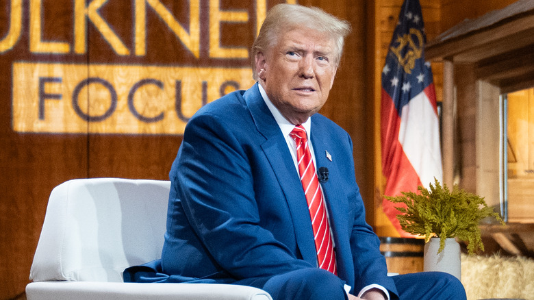 Donald Trump sitting on white chair