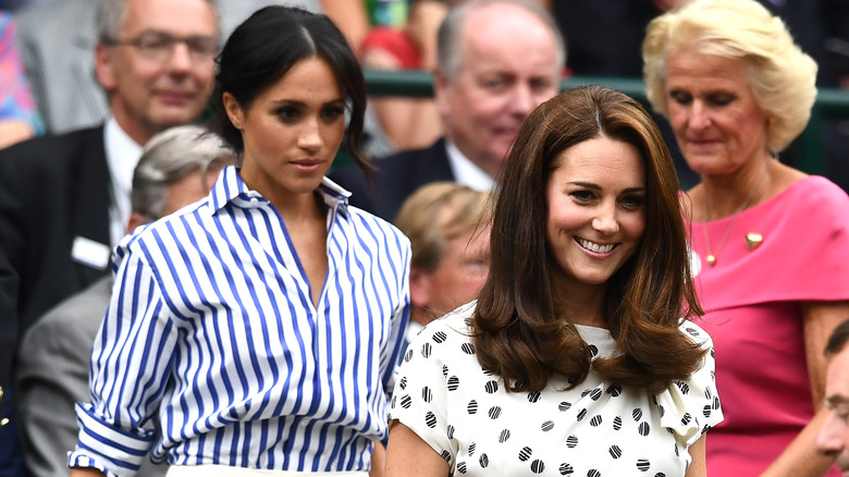 Meghan Markle and Kate Middle standing at an event