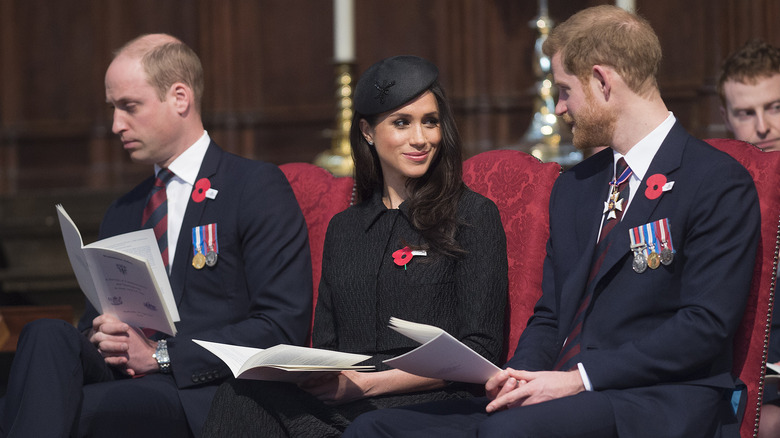 Prince William, Meghan Markle and Prince Harry sitting together at an event