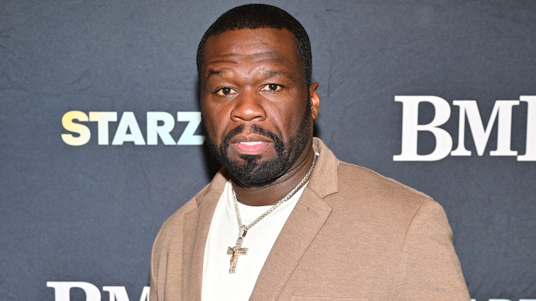 50 Cent poses for photos at a premiere event