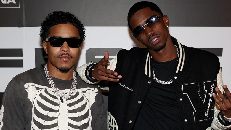 Justin and Christian Combs posing together on step-and-repeat