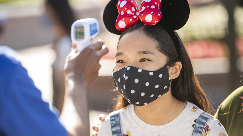 girl getting temperature checked at Disney World