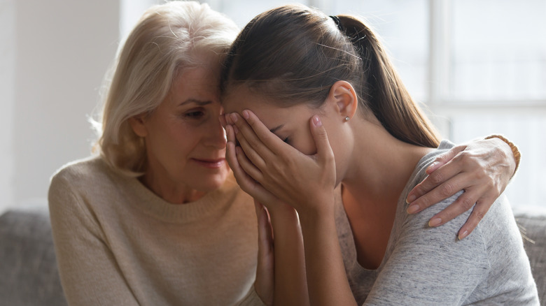 older woman comforting sad woman