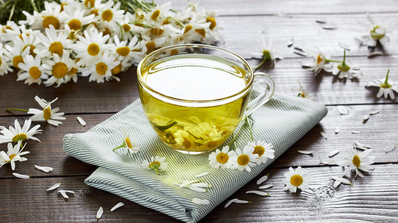 Chamomile tea surrounded by flowers