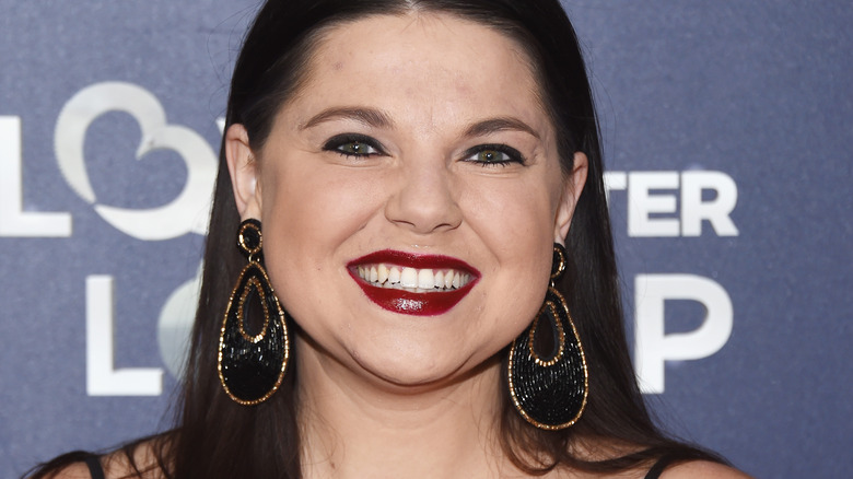 Amy Duggar King smiling at an event