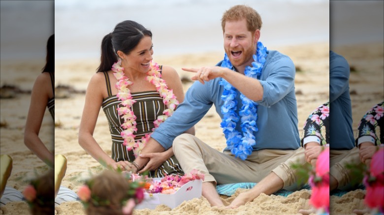 Prince Harry touching Meghan Markle's thigh on beach