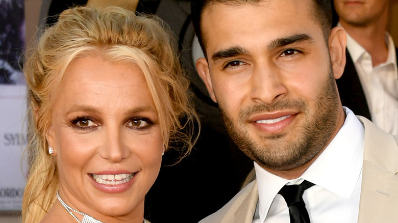 Britney Spears and Sam Asghari pose together at an event