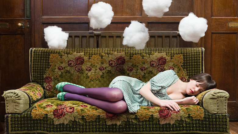 Woman dreaming on sofa