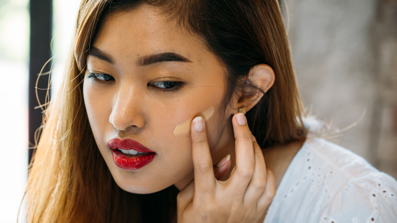 Woman applying foundation 