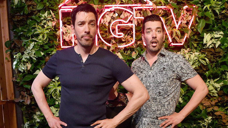 Drew and Jonathan Scott posing at HGTV event