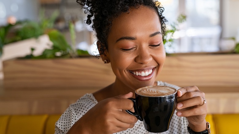Black woman smiling drink coffee