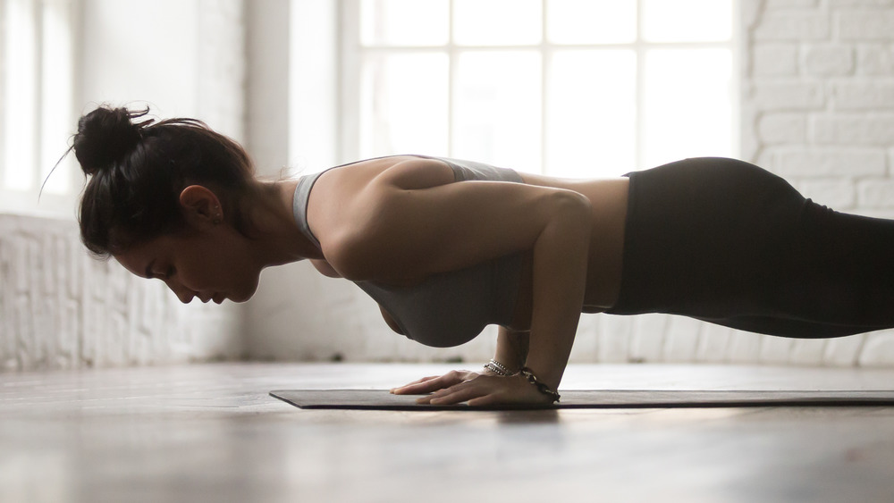 a woman doing push-ups in her home