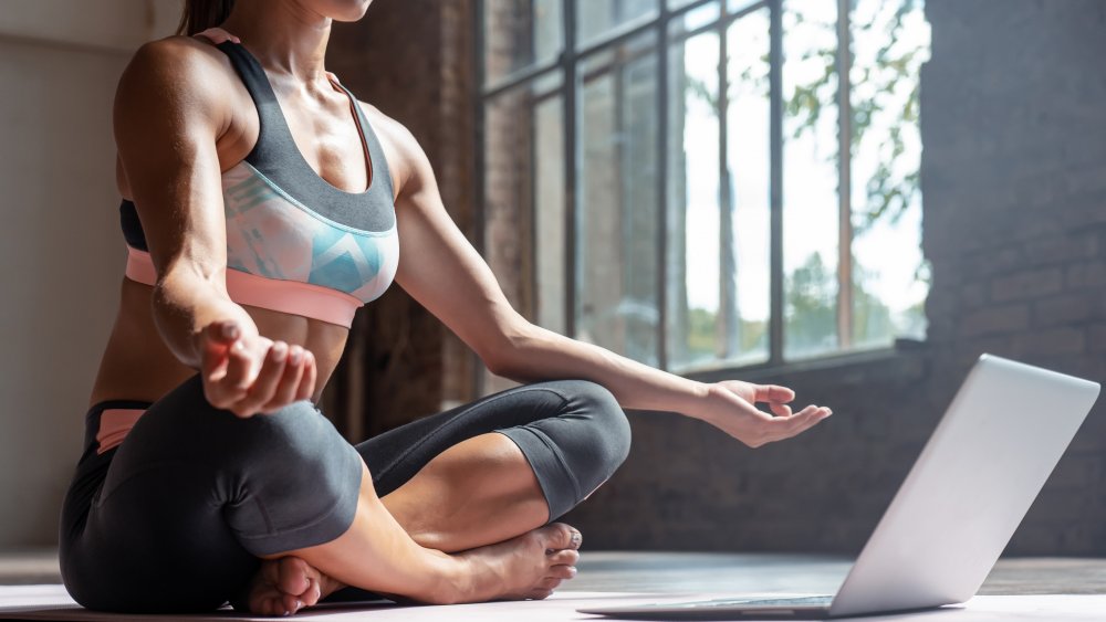 Woman doing online yoga class