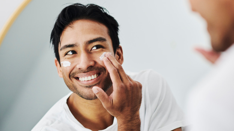 Man applying sunscreen