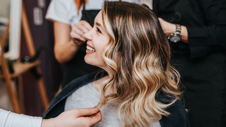 smiling woman at hair salon 