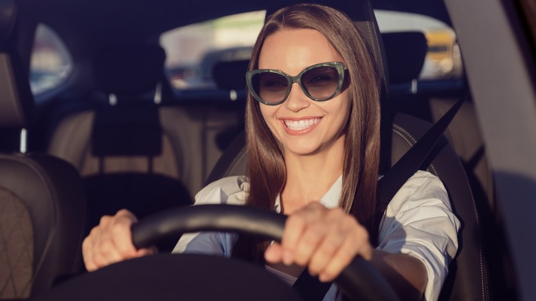 Woman wearing sunglasses in a car