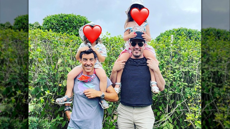 Jacob Pechenik and Jonathan Scott carrying Pechenik and Deschanel's children on their shoulders