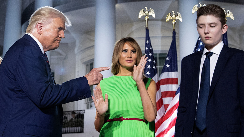 Donald Trump points to Barron with Melania in background