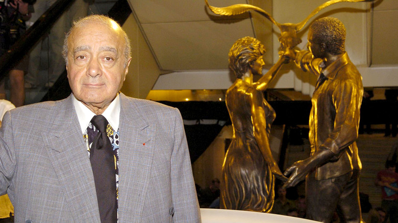 Mohamed Al-Fayed in front of memorial statue