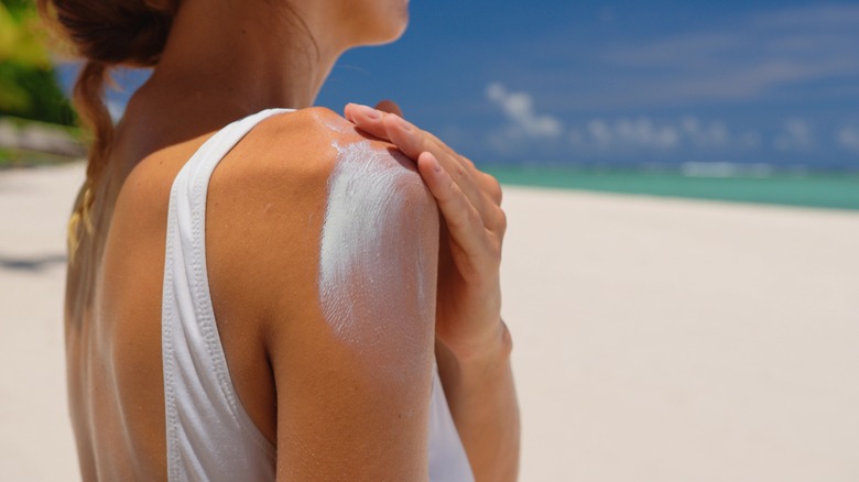 Woman applying sunscreen to arm