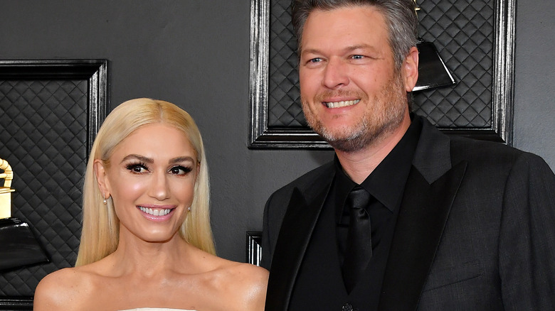 Gwen Stefani and Blake Shelton on red carpet smiling