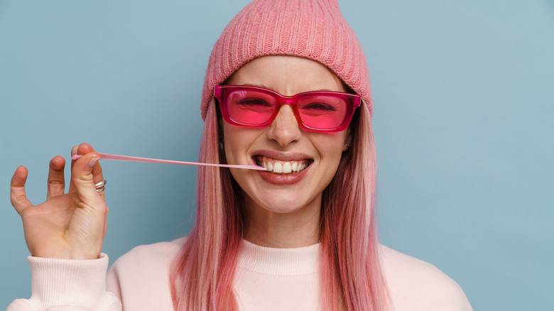 Woman stretching piece of gum