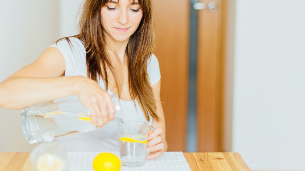 Woman preparing lemon water