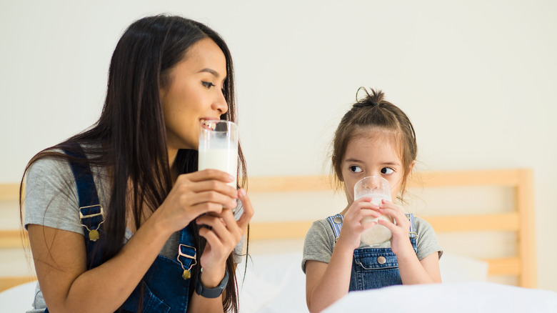 woman and child drinking milk 