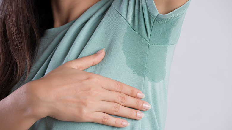 Woman with sweat-stained underarm