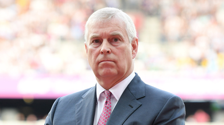 Prince Andrew, Duke of York, holds a stern face while at an event