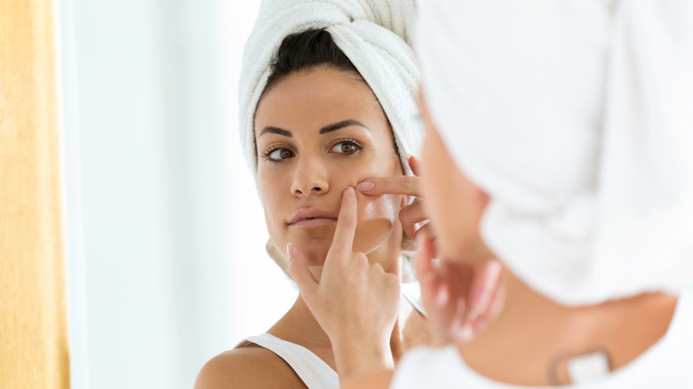 woman picking pimples