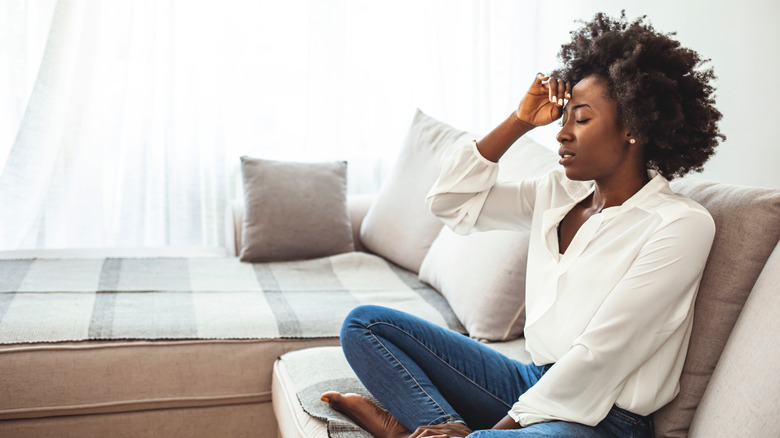 Frustrated woman sitting on the sofa