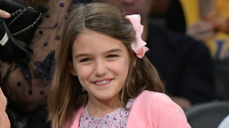 Suri Cruise smiling at a basketball game in 2017