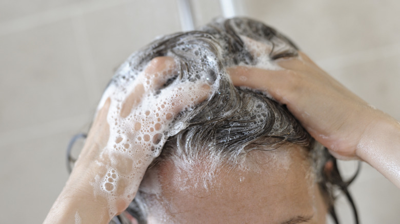 woman shampooing hair