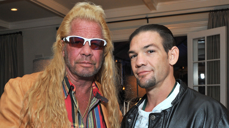 Duane Chapman standing with Leland Chapman at the 2013 Electus & College Humor Holiday Party