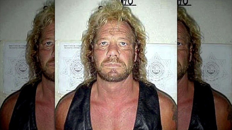 Dog The Bounty Hunter posing for a mugshot