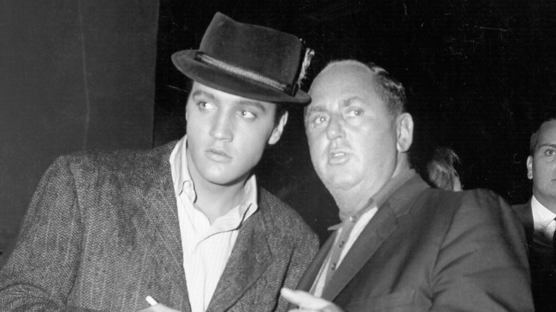 Elvis Presley and Col. Tom Parker standing together