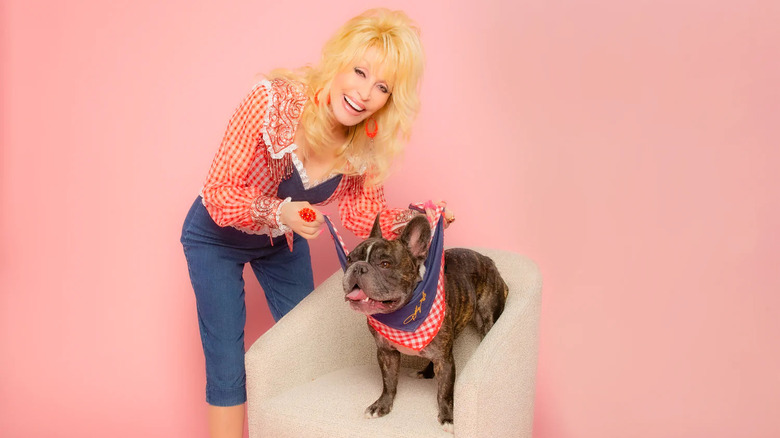 Dolly Parton with her dog wearing a bandana