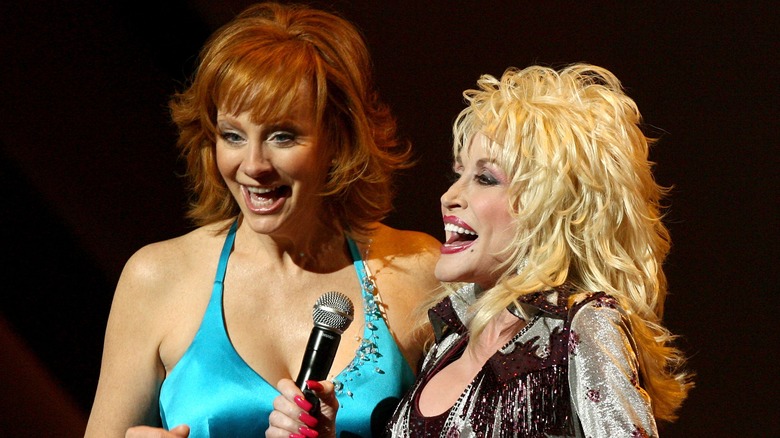 Dolly Parton performing with Reba McEntire