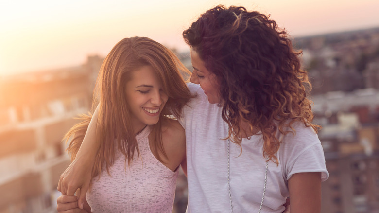 Couple hugging in front of sunset