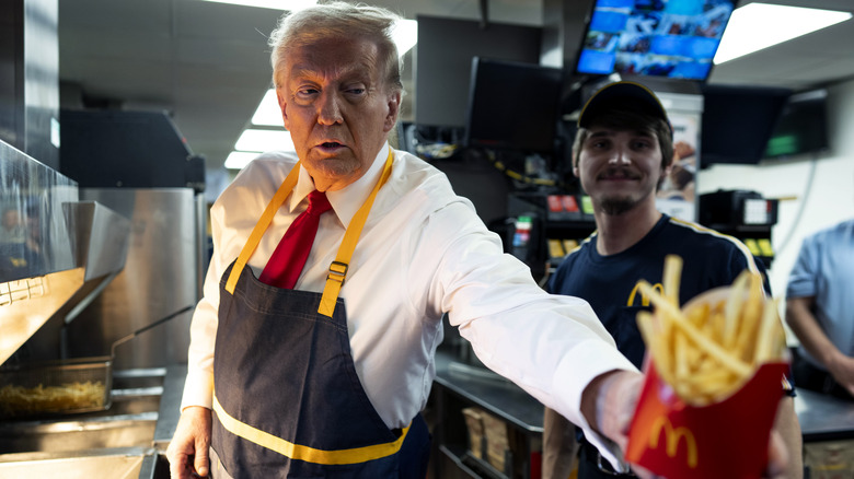 Donald Trump handing fries to someone at McDonald's