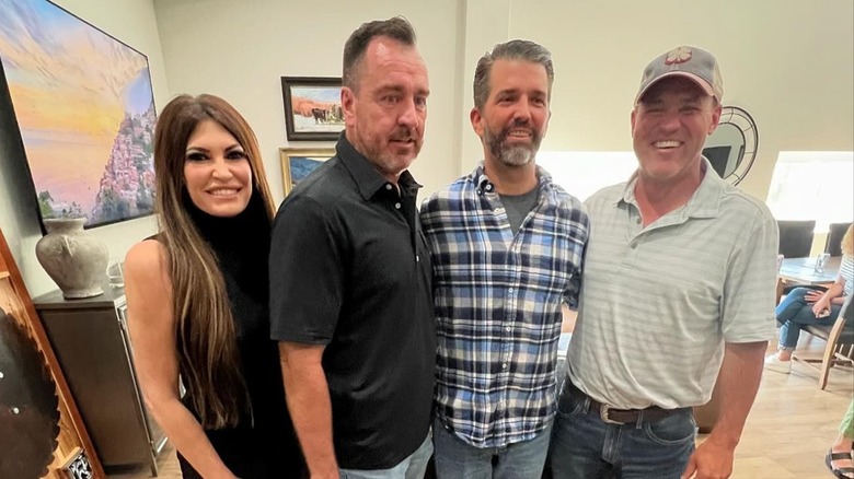 Kimberly Guilfoyle and Donald Trump Jr. standing awkwardly in a group photo