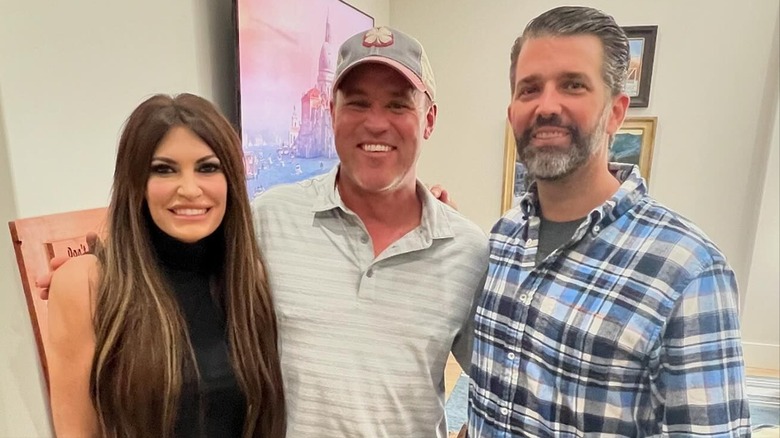 Kimberly Guilfoyle, Mike Schultz, and Donald Trump Jr. smiling